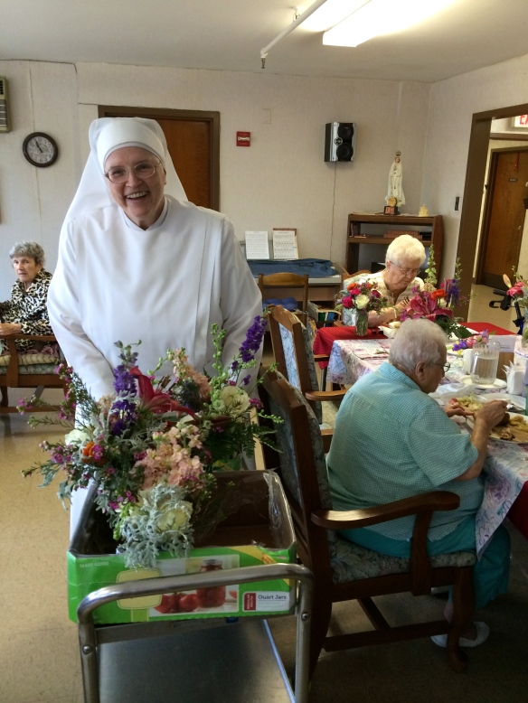 Sister Elizabeth Ann distributing arrangements