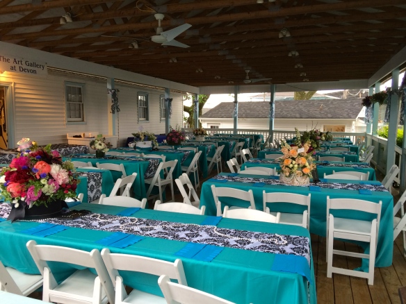 Preferred seating and Luncheon area displaying floral centerpieces in hat boxes